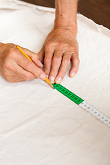 Image showing Hand Cutting Cloth with Scissors