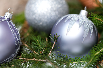 Image showing Silver Christmas ornaments in leaves