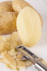 Image showing Potatoes with Peeler and Peeled Skin