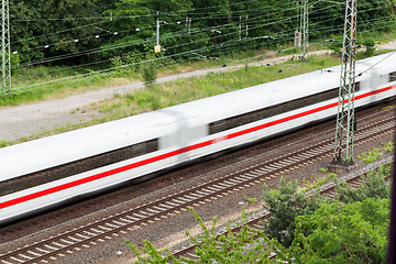 Image showing Fast moving train with red stripe