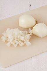 Image showing Whole, peeled and diced brown onion