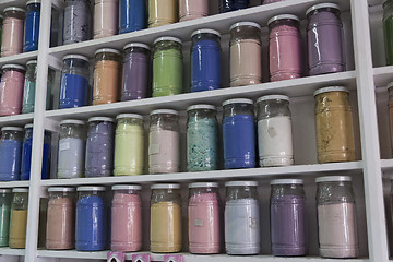 Image showing Shelving with glass jars of colorful pigments