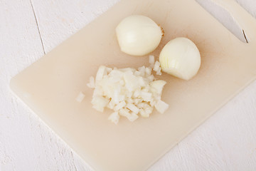 Image showing Whole, peeled and diced brown onion