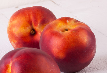 Image showing Three tasty fresh ripe juicy nectarines