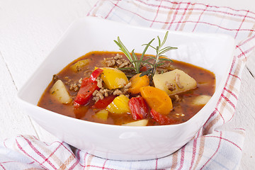 Image showing Hearty Stew in Bowl and Spoon on Plaid Dish Towel