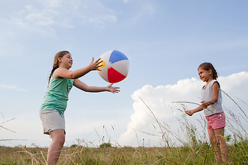 Image showing Young girls playing with a ball outdoors