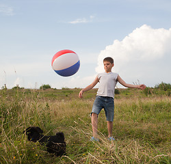 Image showing Young boy playing with a ball outdoors