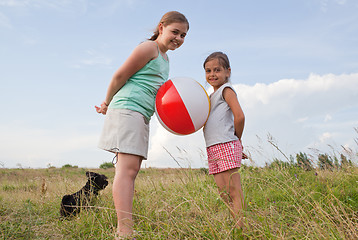 Image showing Young girls playing with a ball outdoors