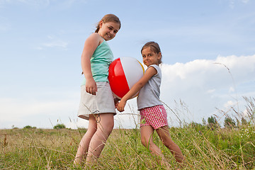 Image showing Young girls playing with a ball outdoors