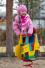 Image showing Little girl on the carousel in the autumn