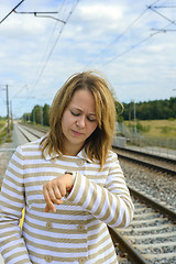 Image showing Portrait of a beautiful woman watching her watch