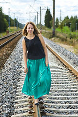 Image showing Walking girl on the railway