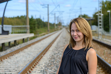 Image showing Portrait of girl between two railway path