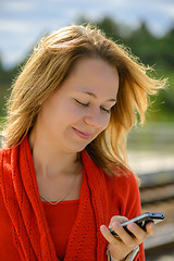 Image showing Happy young caucasian girl with smart phone