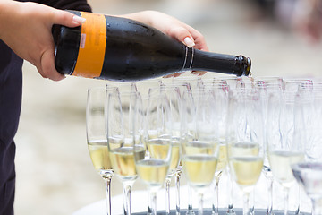 Image showing Pouring champagne into glasses