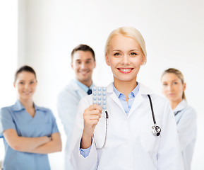 Image showing smiling female doctor with pills