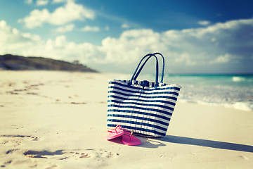 Image showing close up of beach bag and slippers at seaside