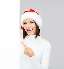 Image showing woman in santa helper hat with blank white board