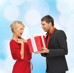 Image showing smiling man and woman with present