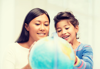 Image showing mother and daughter with globe