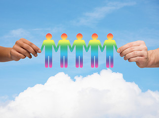 Image showing close up of hands holding paper chain gay people