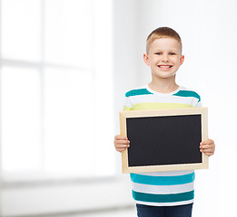 Image showing smiling little boy holding blank black chalkboard