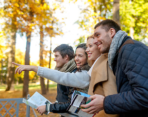 Image showing group of friends with map outdoors