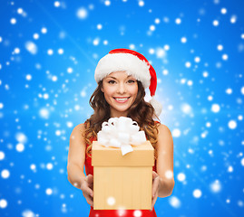 Image showing smiling woman in red dress with gift box