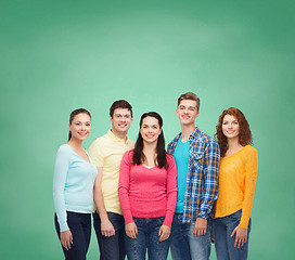 Image showing group of smiling teenagers over green board