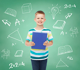 Image showing smiling little student boy with blue book