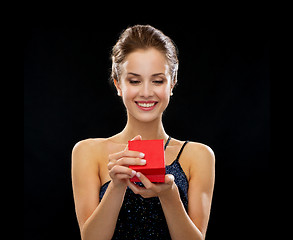 Image showing smiling woman holding red gift box