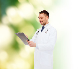 Image showing smiling male doctor with clipboard and stethoscope