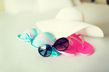 Image showing bikini top, hat, flip-flop and sunglasses