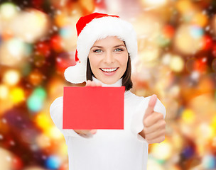 Image showing woman in santa helper hat with blank red card