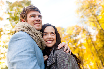 Image showing smiling couple hugging in autumn park