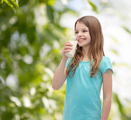 Image showing smiling little girl drinking milk out of glass