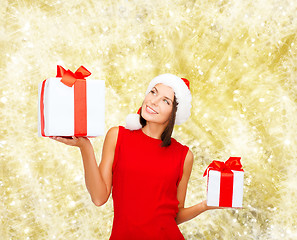 Image showing smiling woman in red dress with gift box