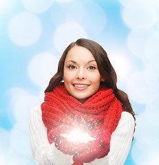 Image showing smiling woman in winter clothes with snowflake