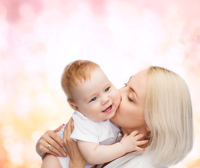 Image showing happy mother kissing smiling baby