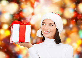 Image showing smiling woman in santa helper hat with gift box