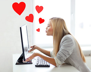 Image showing woman sending kisses with computer monitor