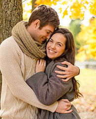 Image showing smiling couple hugging in autumn park