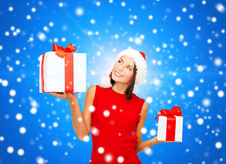 Image showing smiling woman in red dress with gift box