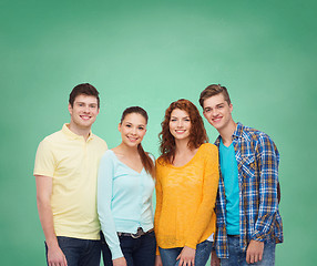 Image showing group of smiling teenagers over green board