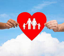 Image showing couple hands holding red heart with family