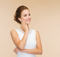Image showing smiling woman in white dress with diamond ring