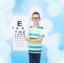 Image showing smiling boy in eyeglasses with white blank board