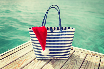 Image showing close up of beach bag and santa helper hat