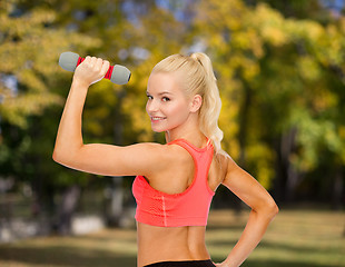 Image showing young sporty woman with light dumbbell