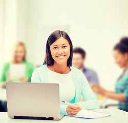 Image showing asian businesswoman with laptop and documents